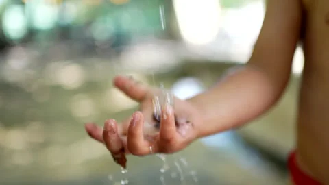 Child washing hands outside during heat day. Refreshing water during summer.. Stock Footage 245421784