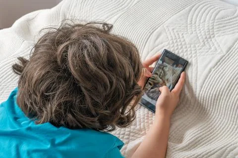 Child watching cat content on digital device Stock Photos
