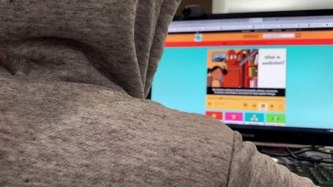 Child watching an educational video on the computer screen. Online distant Video stock 127875808