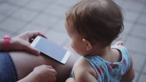 Child is watching something on the smartphone Stock Footage 76759860