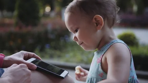 Child is watching something on the smartphone Stock Footage 76760016