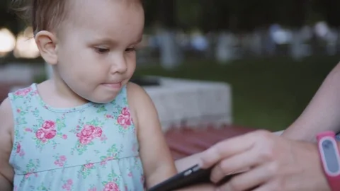 Child is watching something on the smartphone Stock Footage 76760062