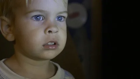 Child Watching Video On Computer TV With Excitement And Attention Close-up Face Stock-Footage 99839159