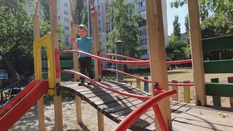A child waves his hand on a playground. Communication, politeness, friendship Stock Footage 301994113