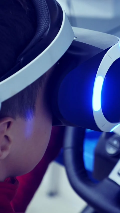 Child wearing virtual reality headset is immersed in digital experience Stock Footage 313258294