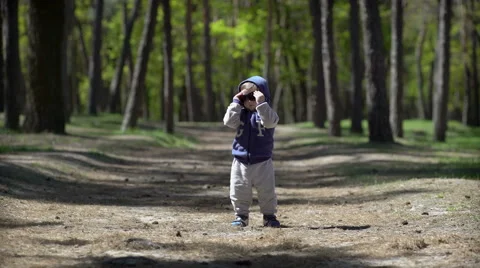 The child wears sunglasses in spring park Stock Footage 62734620