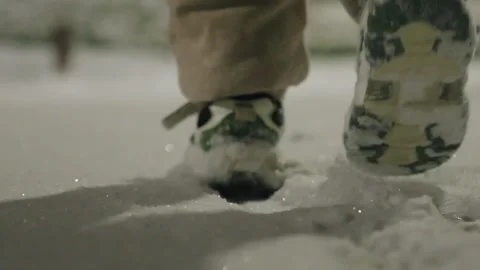 Child in White Snow Boots Walking Through Fresh Powdered Snow 動画素材 337413495