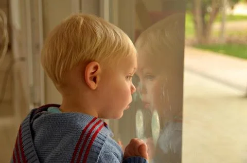 Child at the window Stock Photos