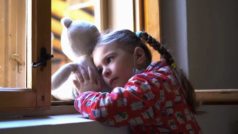 Child by the window with teddy bear. Stock Footage 128809433