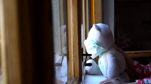 Child by the window with teddy bear. Stock Footage 128809721