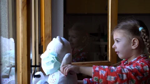 Child by the window with teddy bear. Stock Footage 128809850