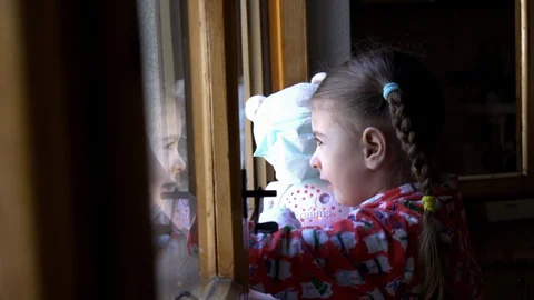 Child by the window with teddy bear. Stock Footage 128809953