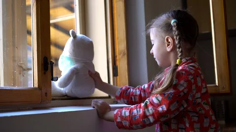 Child by the window with teddy bear. Stock Footage 128812075