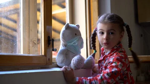 Child by the window with teddy bear. Stock Footage 128812353