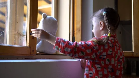 Child by the window with teddy bear. Stock Footage 128812702