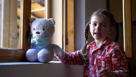 Child by the window with teddy bear. Stock Footage 128812880