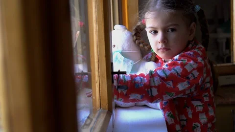 Child by the window with teddy bear. Stock Footage 128814264