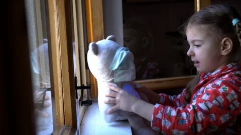 Child by the window with teddy bear. Stock Footage 128814900