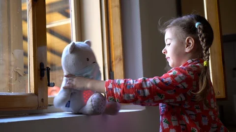 Child by the window with teddy bear. Stock Footage 128817995