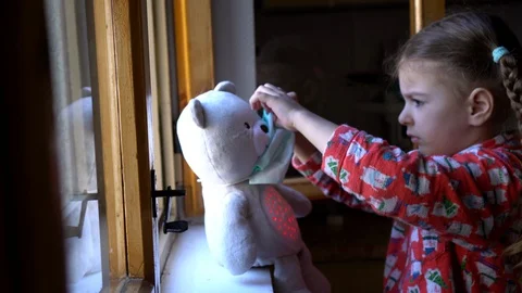 Child by the window with teddy bear. Stock Footage 128818210