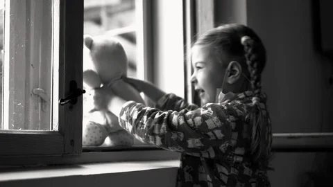 Child by the window with teddy bear. Stock Footage 128818930