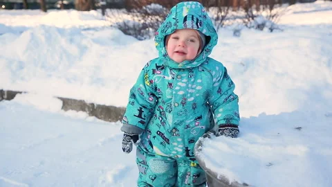 A child in a winter park and the first snow Stock Footage 149756938