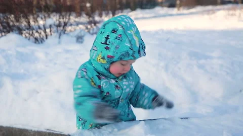 A child in a winter park explores the snow Stock Footage 149756993