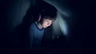The Child In Wireless Headphones Listens To Music At Night Under A Blanket  Stock Footage