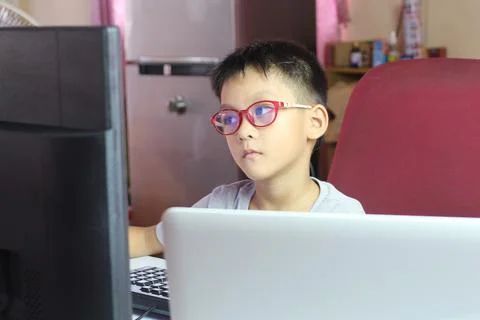 Child Working at Computer in Home Office Environment Stock Photos