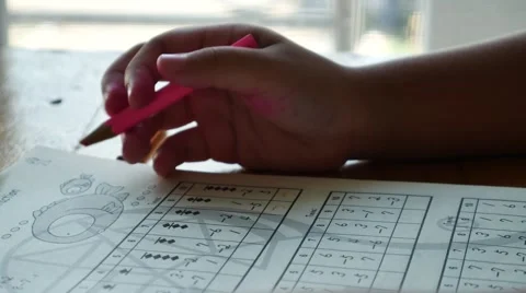 Child working on math homework using graph paper 스톡 동영상 55859409