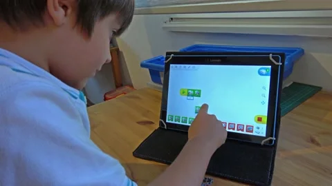 Child working with programme for robot machines Stock Footage 163432489