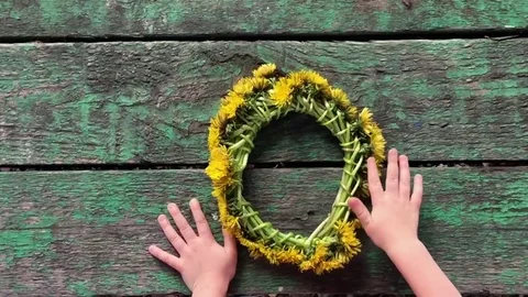 Child with a wreath from dandelions Stock Footage 78783068
