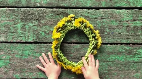 Child with a wreath from dandelions Stock Footage 78945267