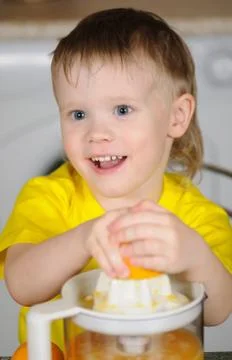 The child to wring out juice Stock Photos