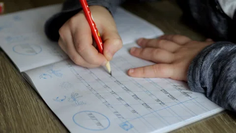 A child writes calligraphy in a notebook  Stock Footage 291318503