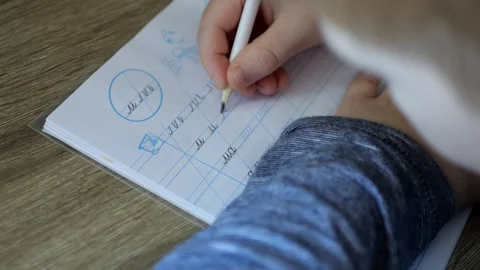 A child writes calligraphy in a notebook  Stock Footage 291318602