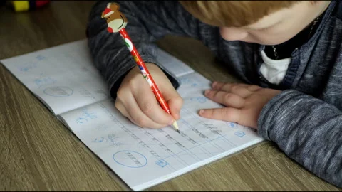 A child writes calligraphy in a notebook  Stock Footage 291318660