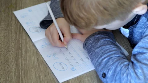 A child writes calligraphy in a notebook  Stock Footage 291318696