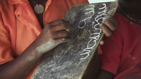 Child writes with chalk on a blackboard Stock Footage 257461614