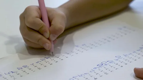 Child writes homework, doing math. Close up Stock Footage 120075220