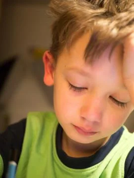 Child writes lessons, distance learning. reluctant to write lessons 写真素材