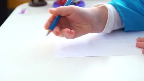 The child writes the letter on paper. Stock Footage 74772374