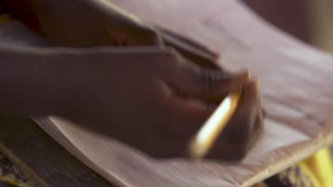 A child writes in a notebook in an African school Stock Footage 257461834