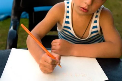 The child writes Stock Photos