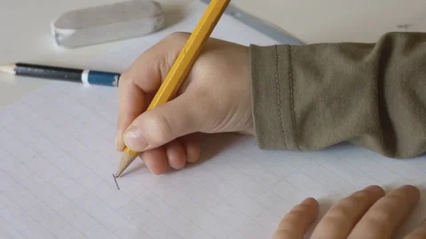 Child writing alphabet letters ABCDE Stock Footage