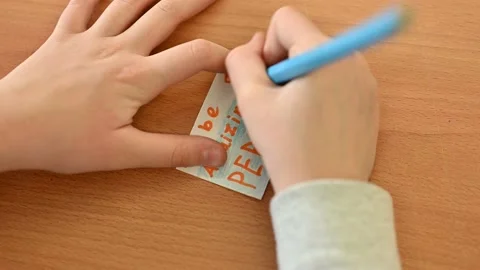 Child writing on a note Stock Footage 169353636