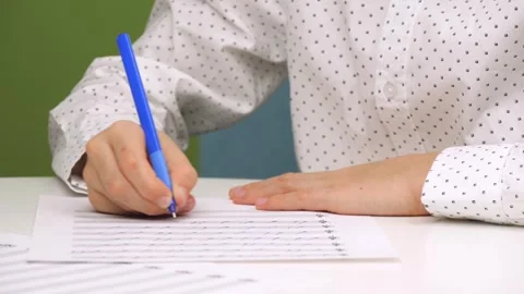 A child is writing on a piece of paper. An unknown child is studying in a music Stock Footage 262307384