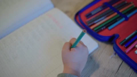 Child writing in print Stock Footage 148473378