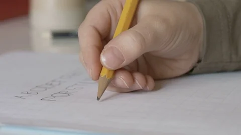Child writing vowels close up Stock Footage 71555259