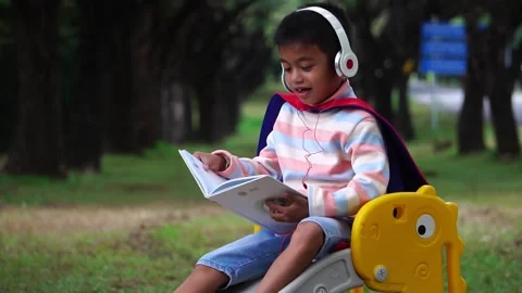 Childen sitting in the park studying 库存影片 221698518